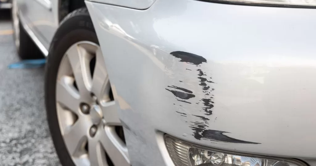 paint scratch on a white car's bumper