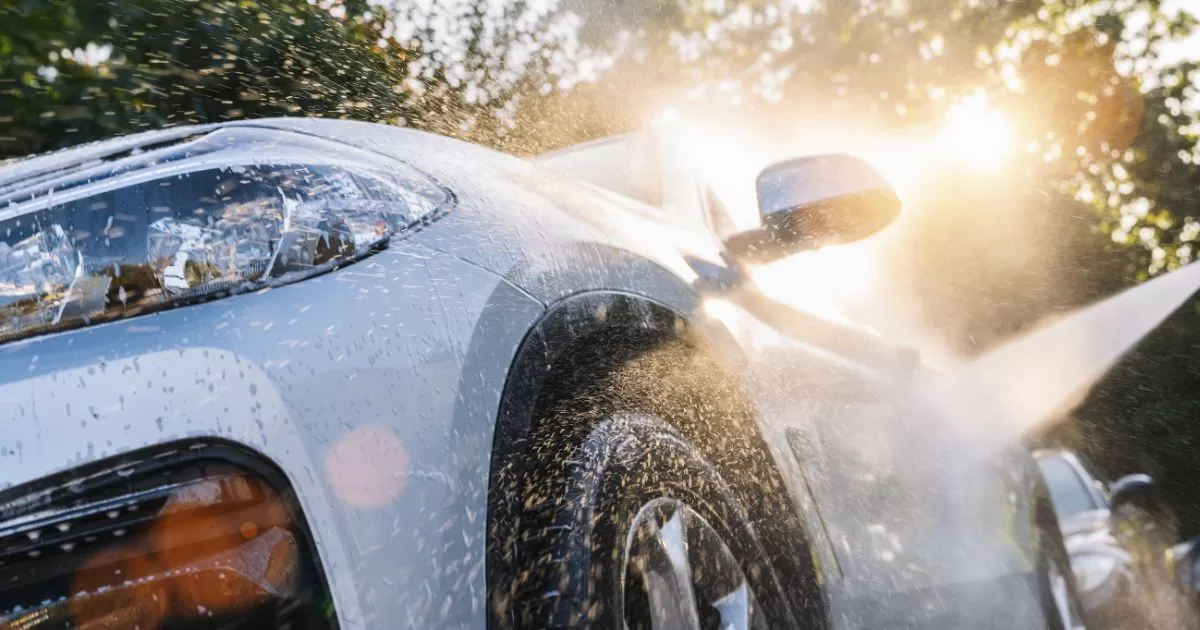 washing car with a hose pipe